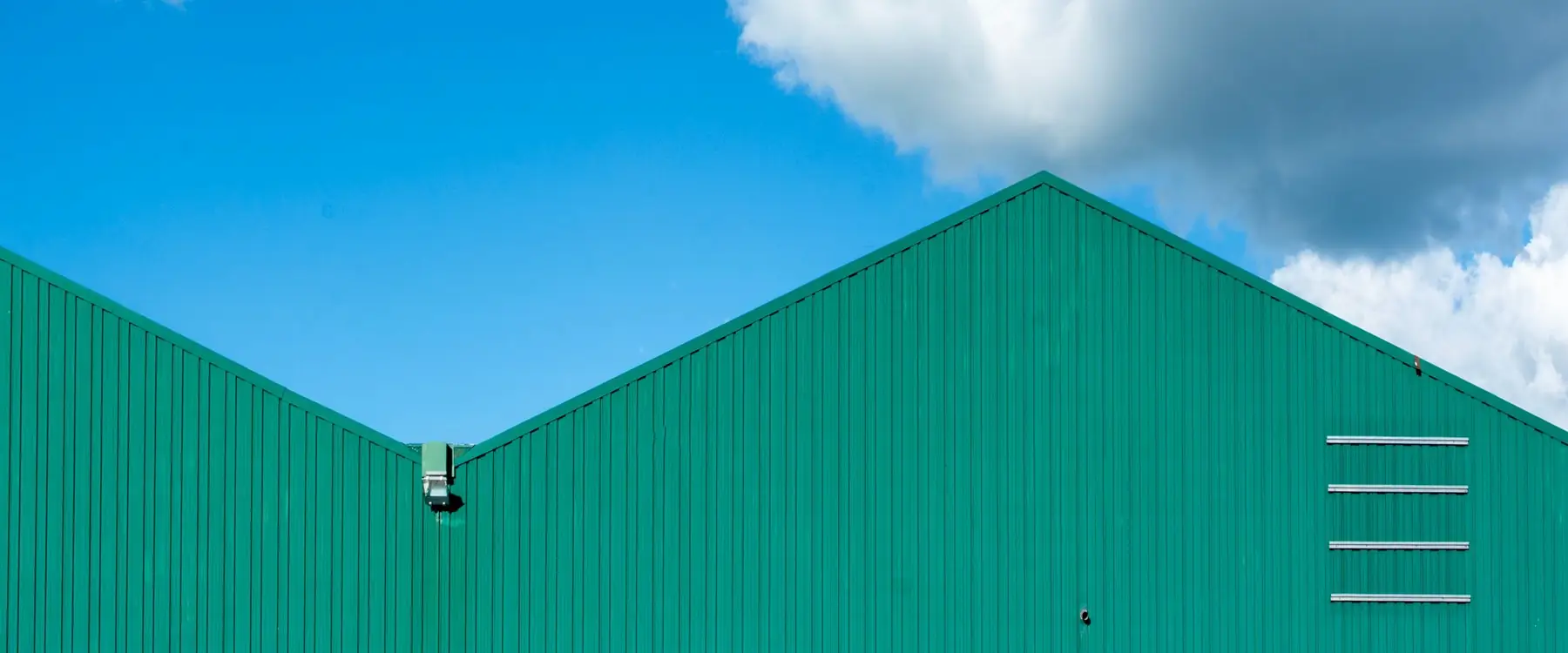 Steel-clad industrial shed with twin gable roofs
